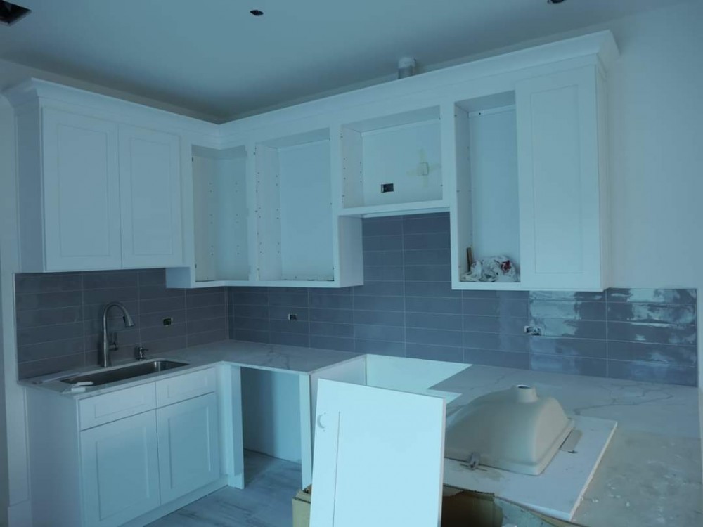 (D) 1 Bedroom Condo - Interior with quartz countertops and subway tile kitchen backsplash in dark grey